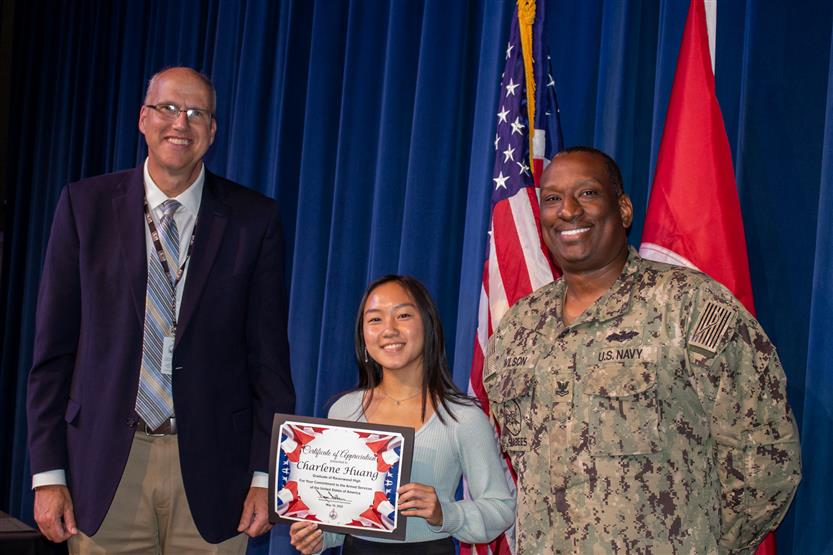 A student is honored for serving in the US Armed Forces after high school